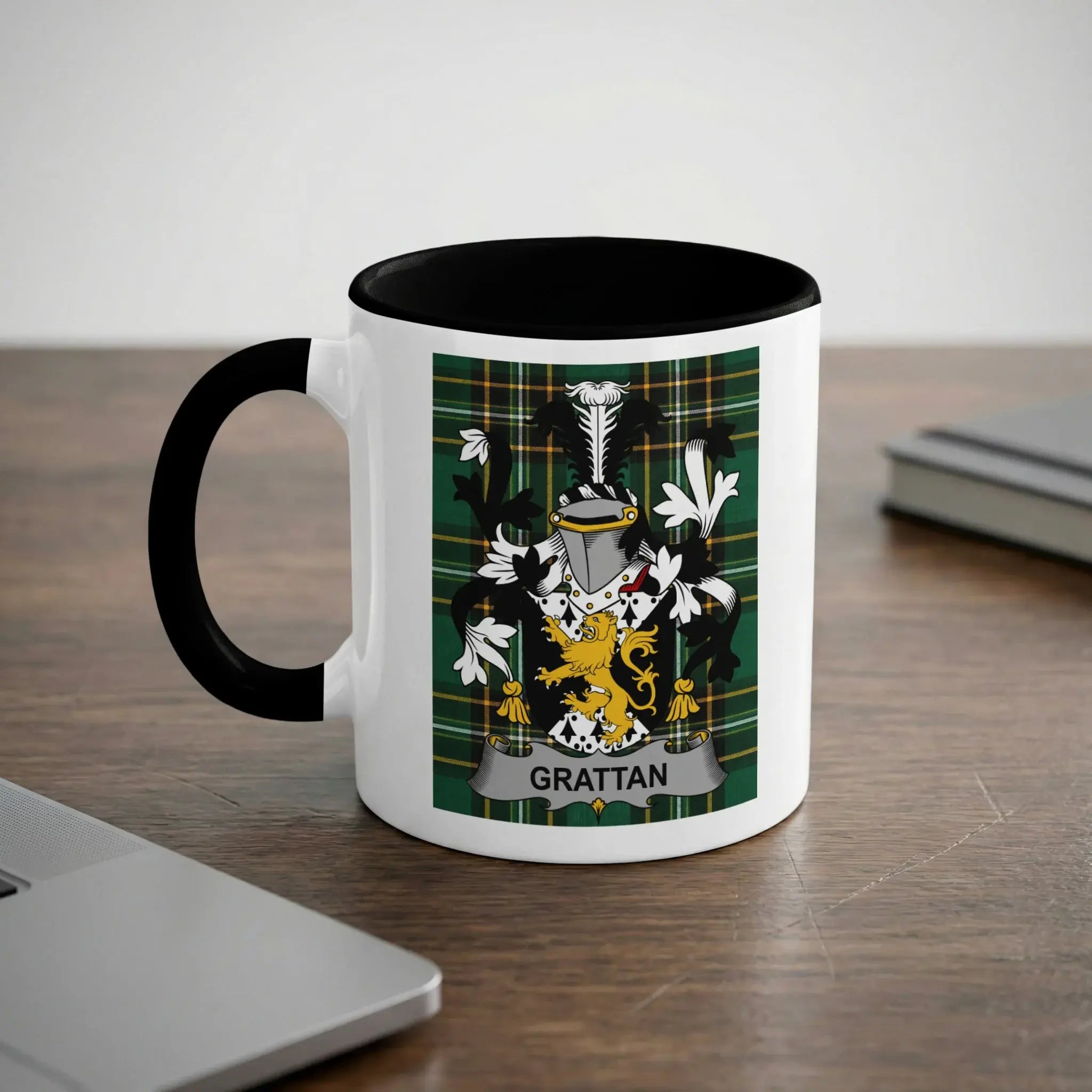 White mug with black rim displaying a green coat of arms with "GRATTAN" text.