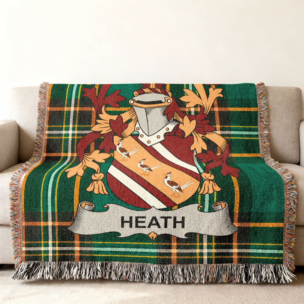 Green plaid throw blanket featuring a family crest with the name "HEATH".