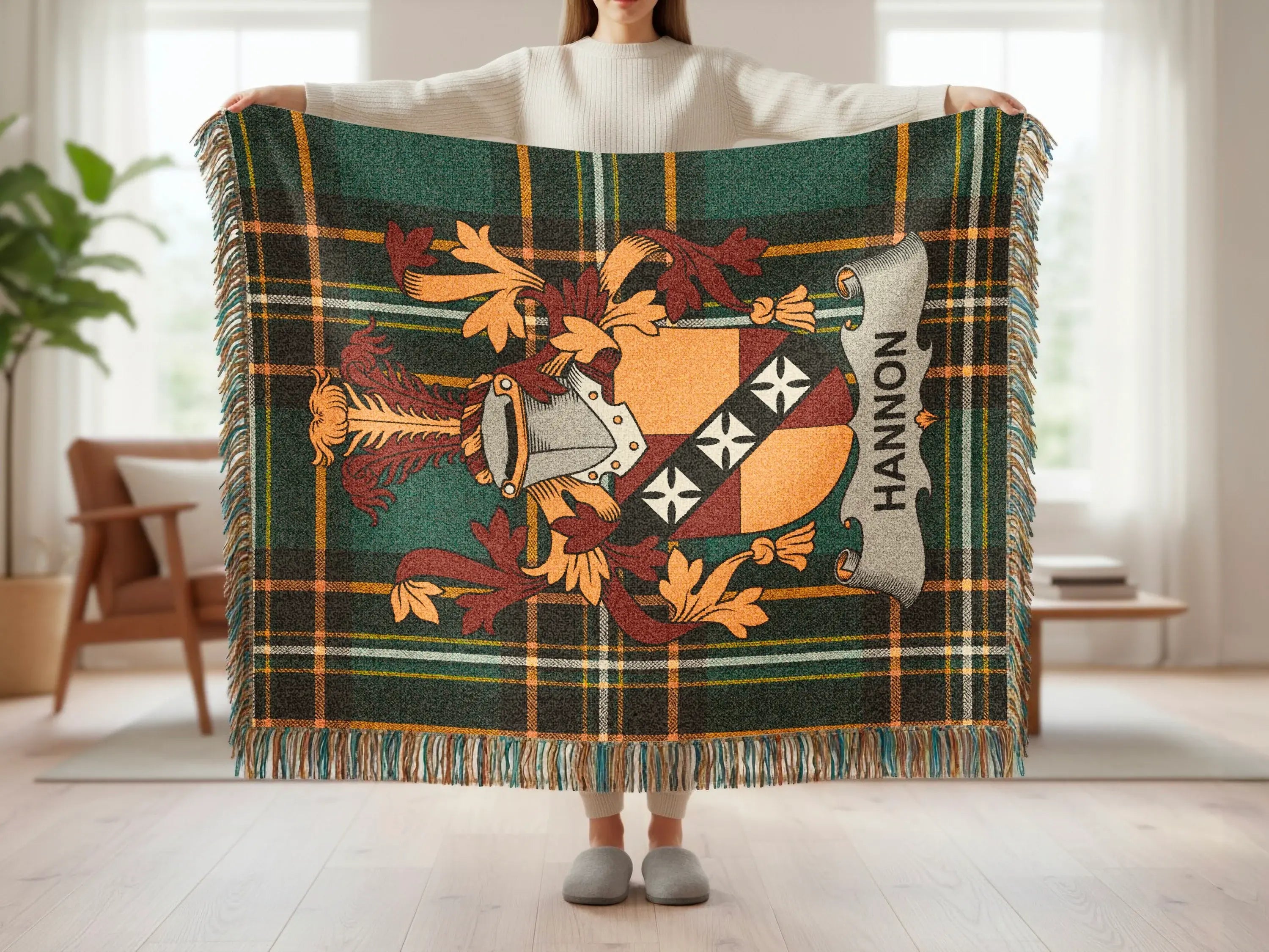 Woven plaid throw blanket with Hannon family crest and fringe.