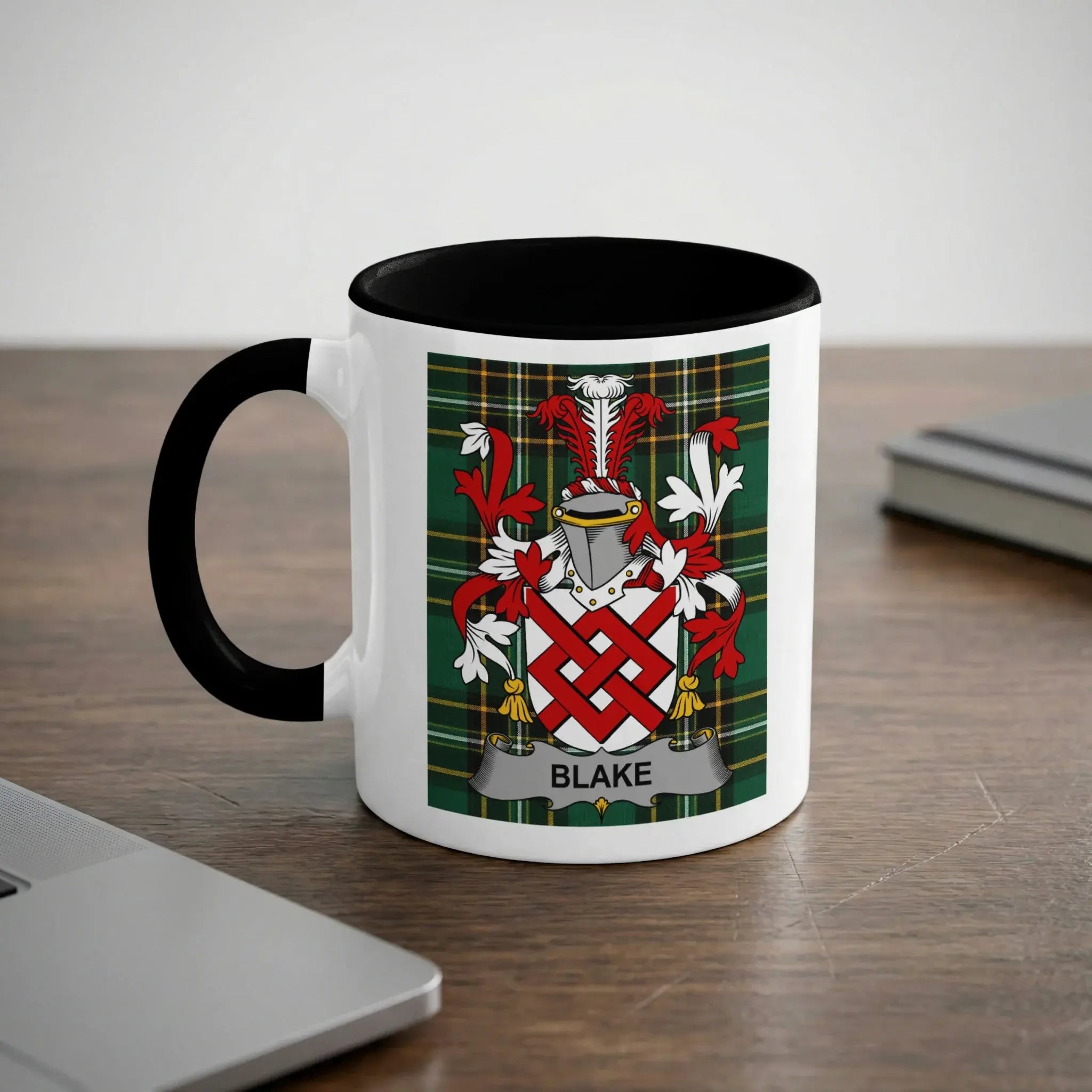 White mug with black handle featuring the Blake family crest on a tartan background.