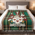 Green tartan blanket with Lally family crest on a bed.