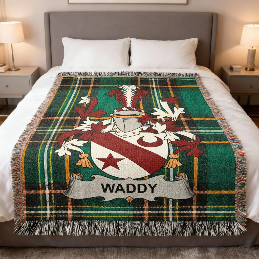 Green plaid blanket with a Waddy family crest centered on it.
