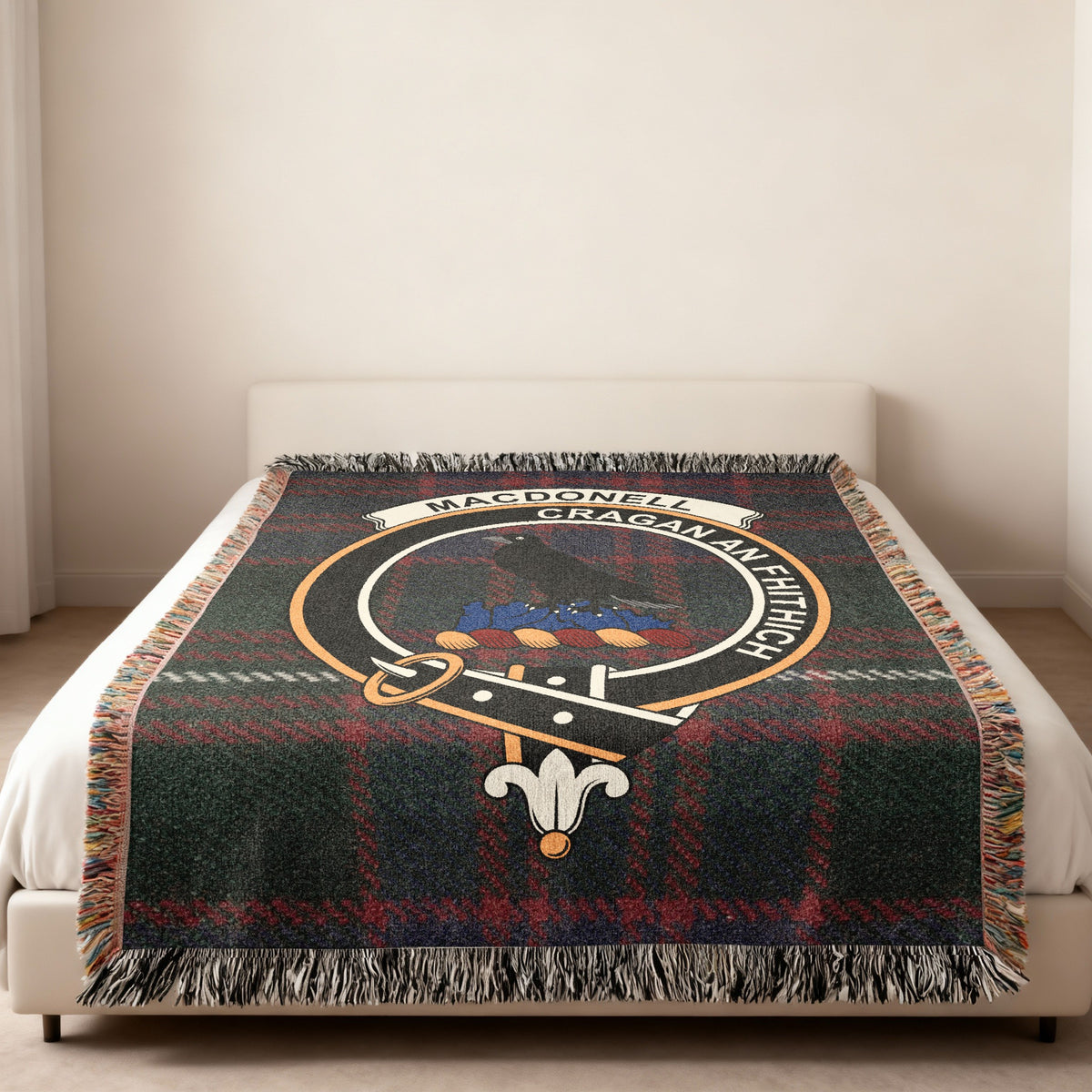 MacDonell of Glengarry Scottish woven blanket spread across a bed, showing the full crest design and tartan background