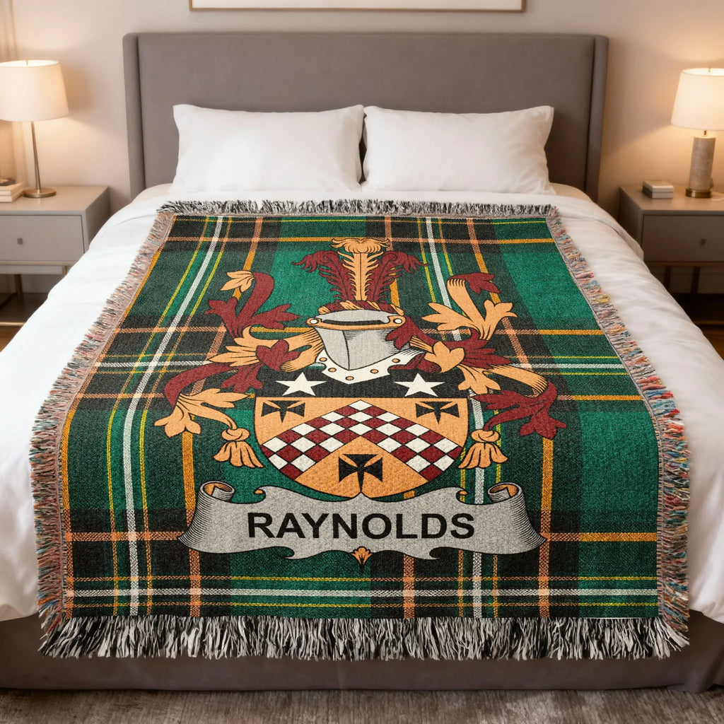 Tartan blanket with Reynolds family crest, draped on a bed.