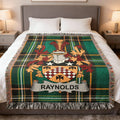 Tartan blanket with Reynolds family crest, draped on a bed.