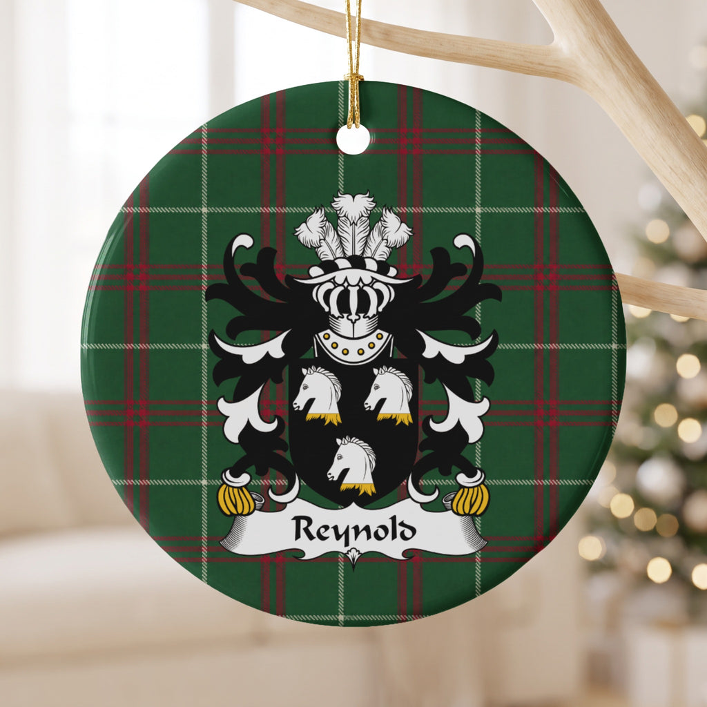 Reynold ceramic ornament with three white horse heads with gold neck details on a black shield on Welsh National Tartan, hanging beside a window.