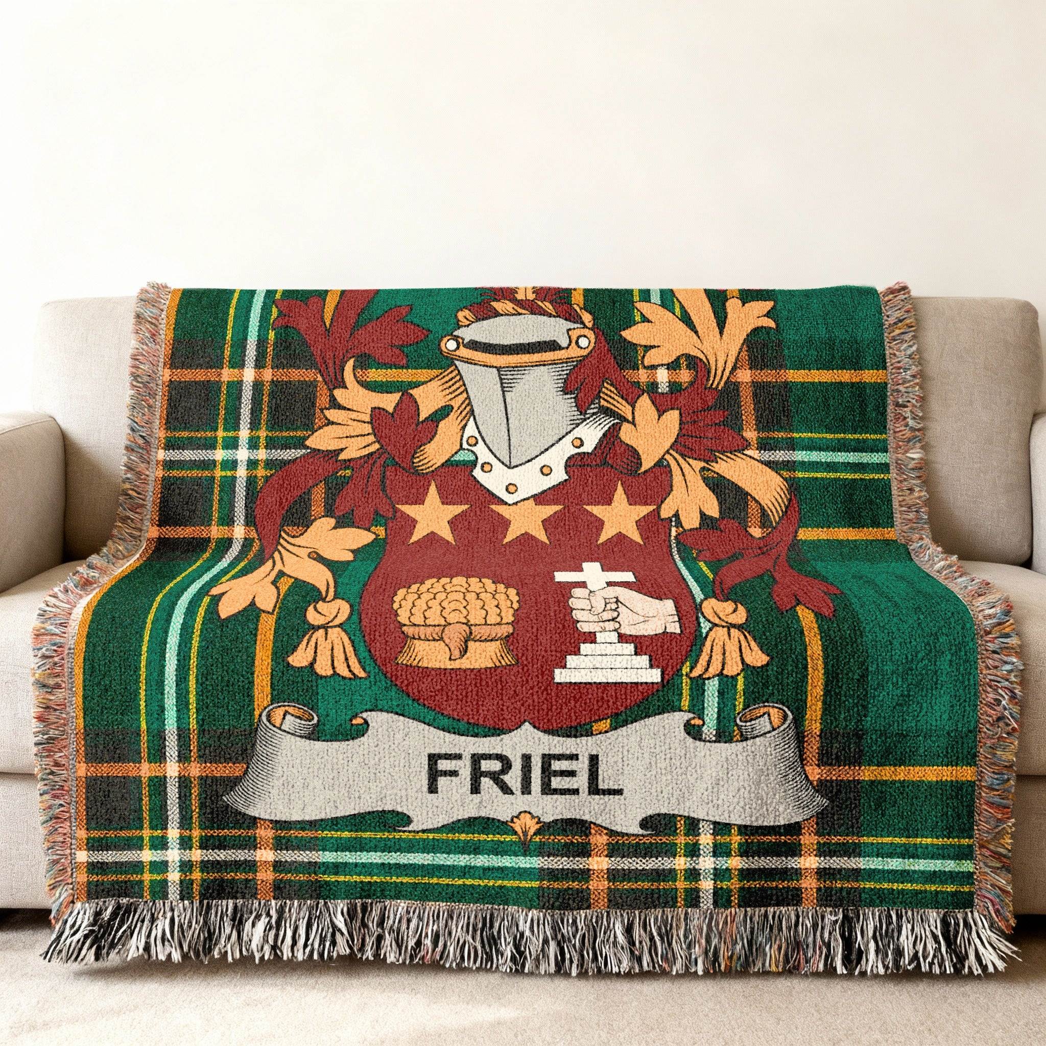 Friel family crest on a green tartan woven blanket draped over a sofa.