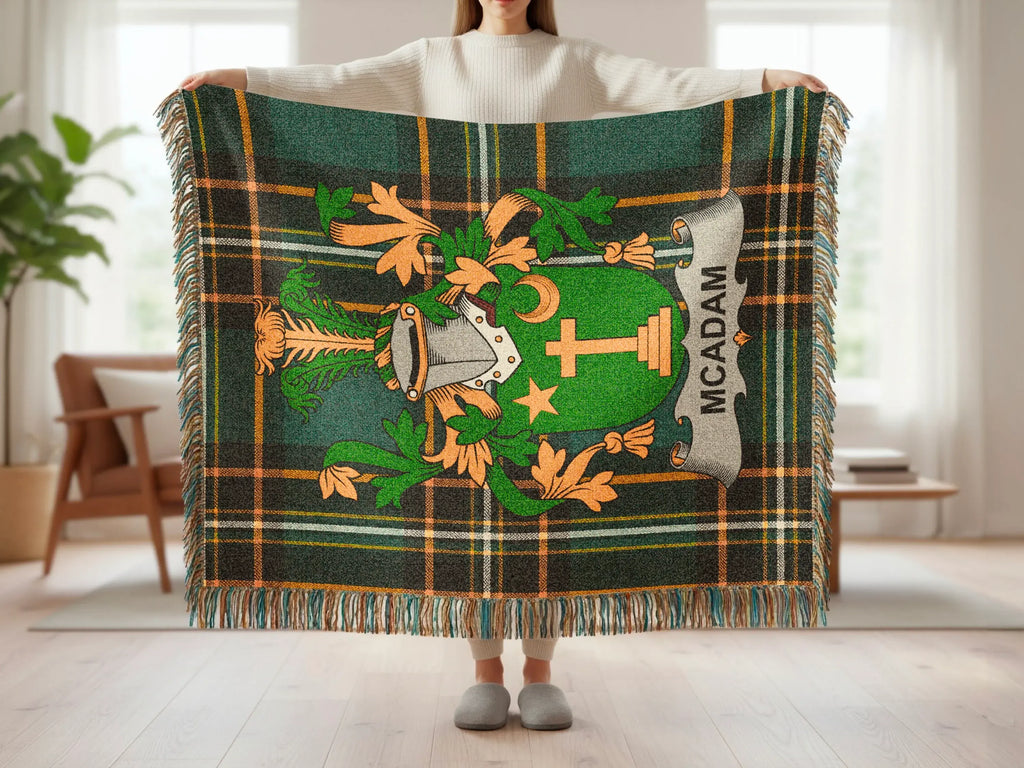 Green plaid throw blanket with a heraldic crest featuring the name MCADAM.