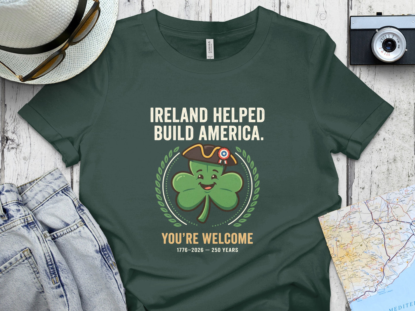 Green t-shirt with shamrock saying "Ireland Helped Build America. You're Welcome."