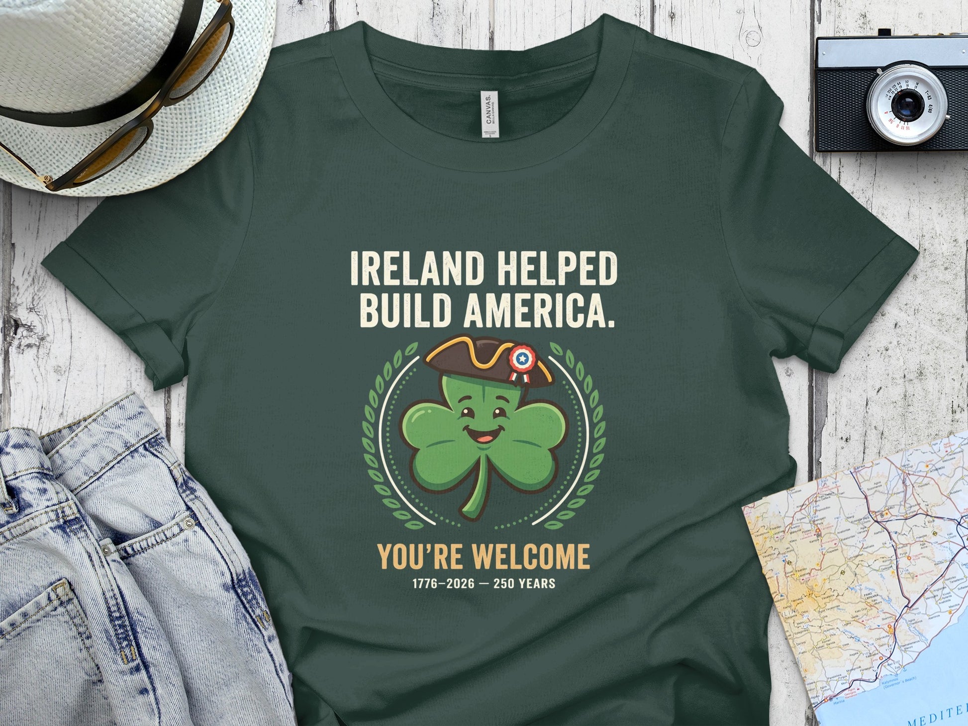 Green t-shirt with shamrock saying "Ireland Helped Build America. You're Welcome."