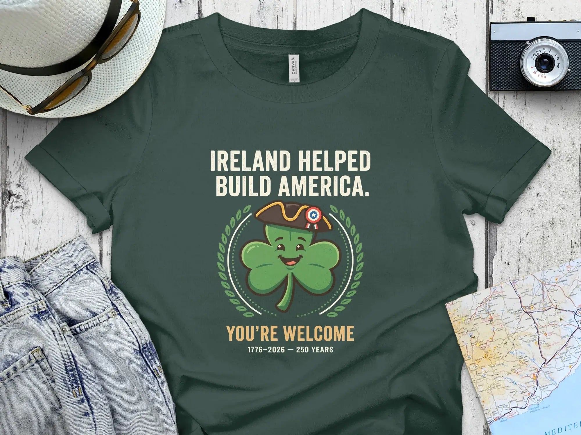 Green t-shirt with shamrock saying "Ireland Helped Build America. You're Welcome."