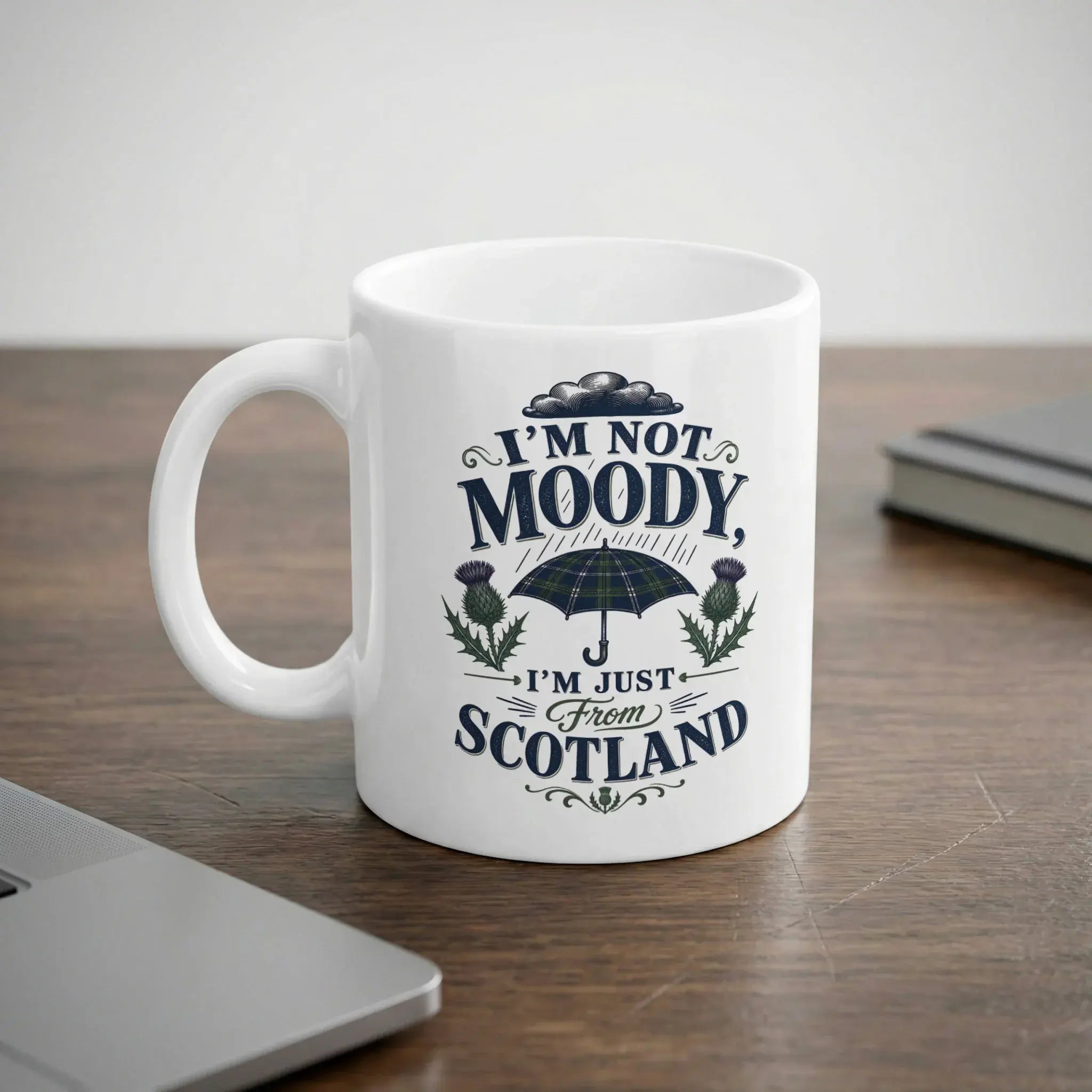White mug with "I'm not moody, I'm just from Scotland" and thistle design.