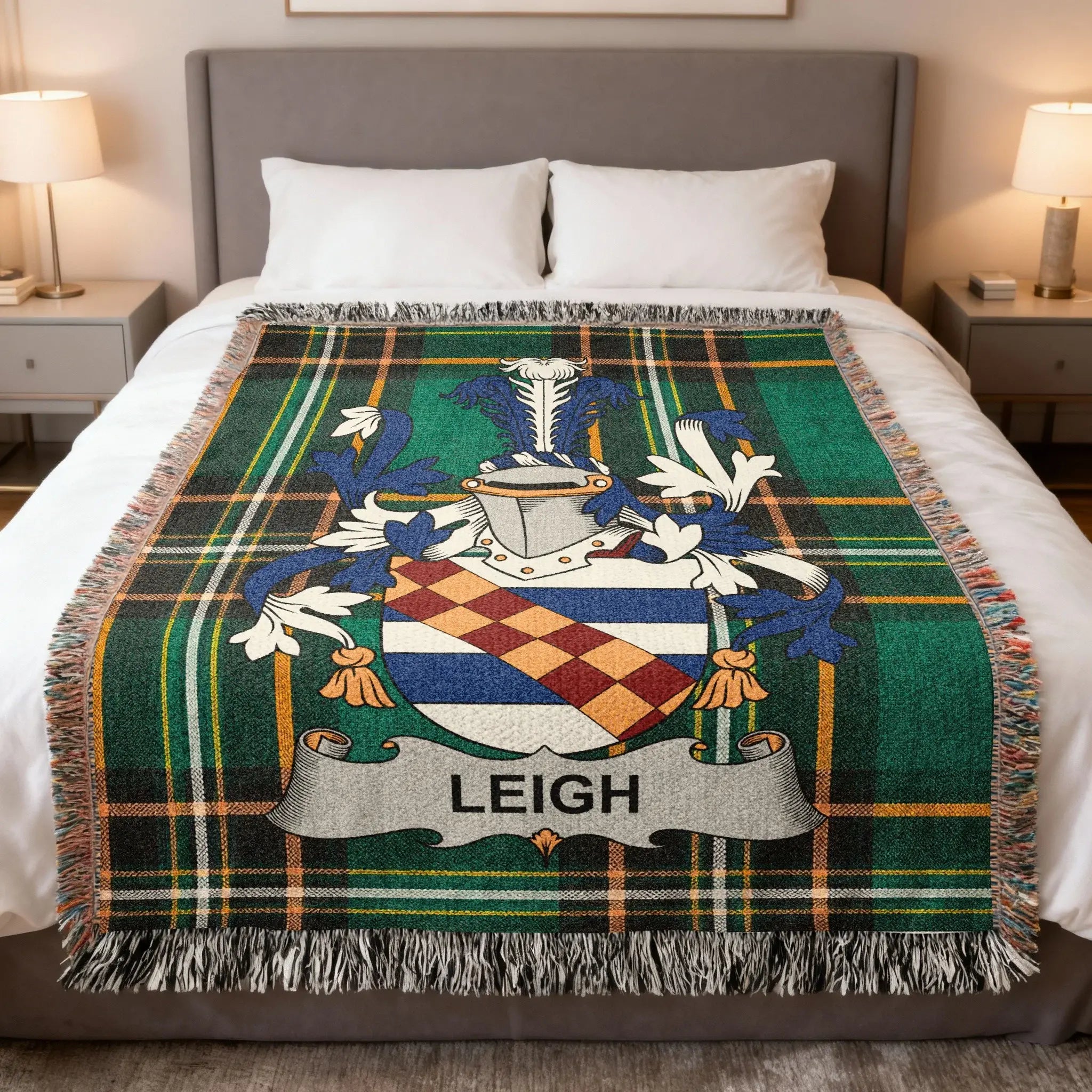 Tartan blanket with a blue, white, and orange coat of arms featuring the name LEIGH.