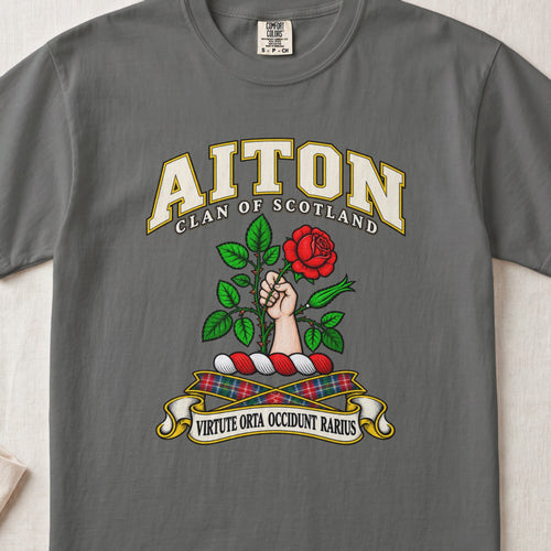 Aiton Scottish clan T-shirt in Pepper, front view with a hand holding a red rose with green leaves and motto design.