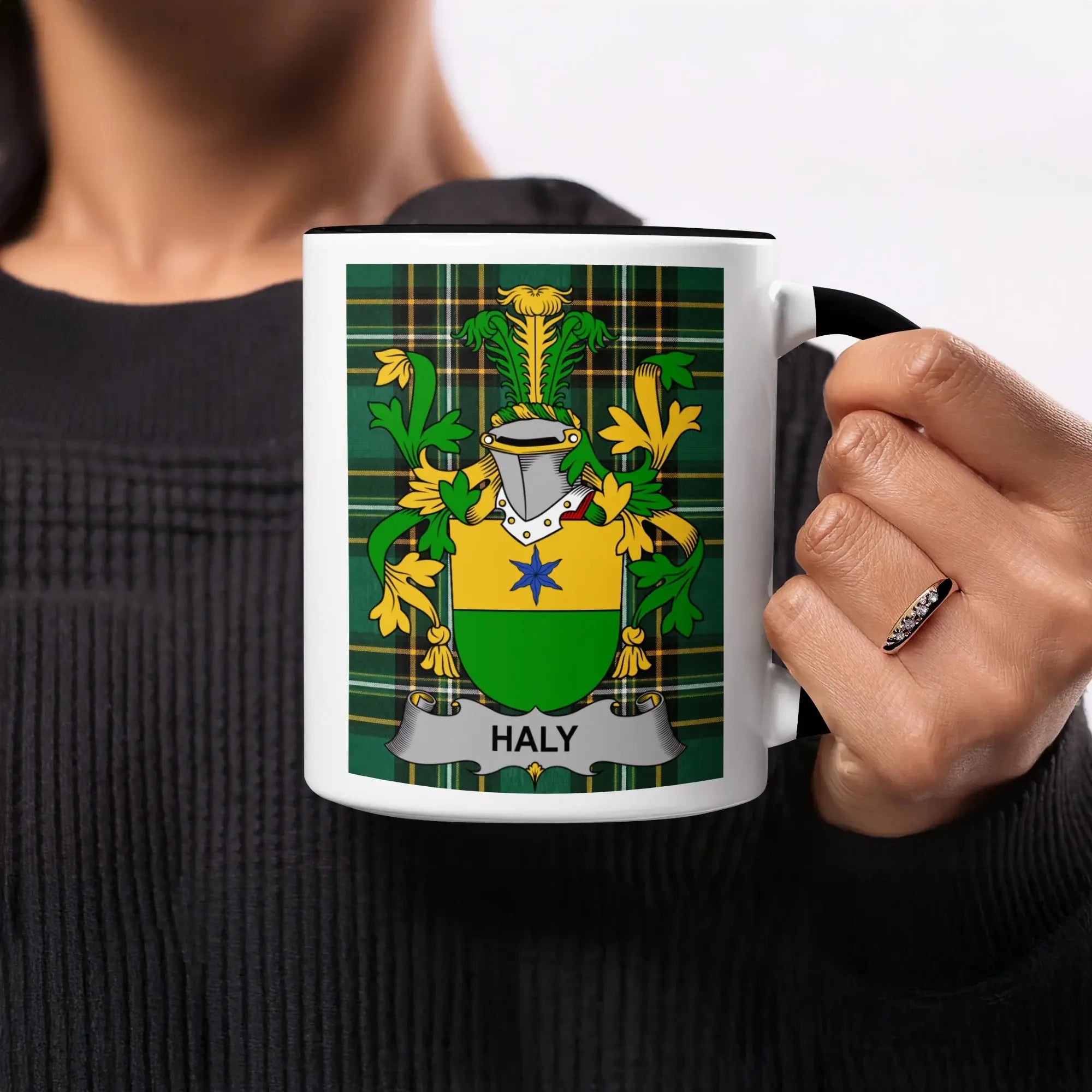 Mug with the Haly family crest on a green tartan background.