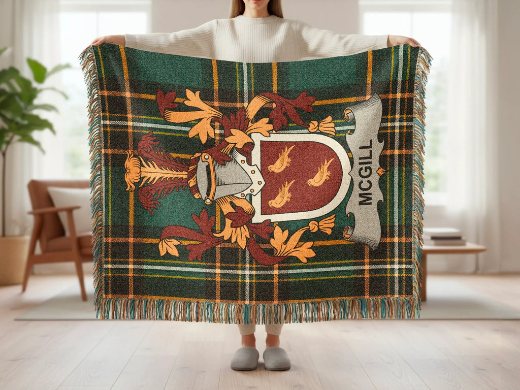 McGill tartan blanket with coat of arms and tassels held by person.