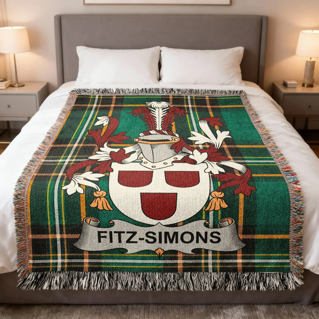 Fitz-Simons family crest on a green tartan blanket with fringed edges.