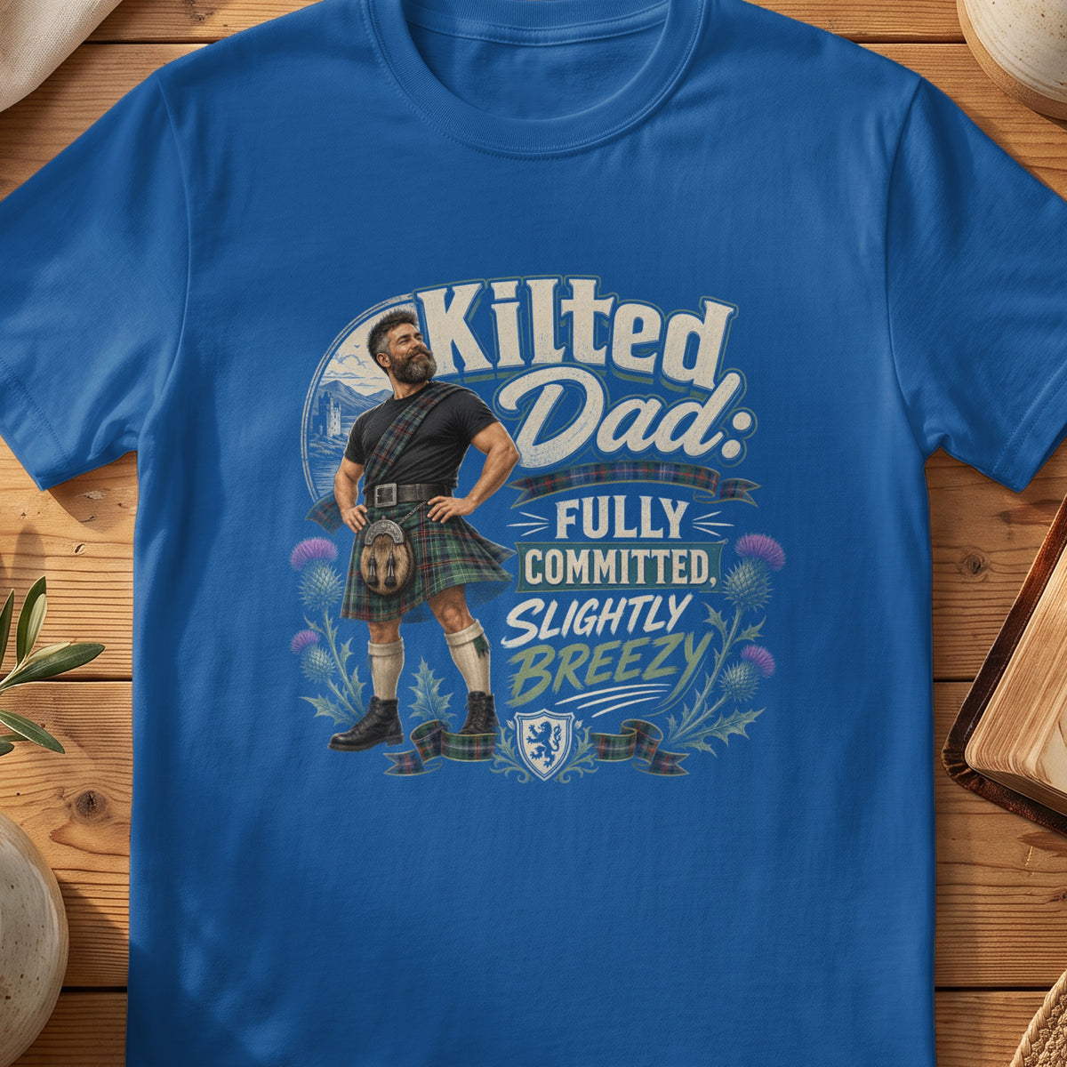 Kilted Dad: Fully Committed, Slightly Breezy graphic on a blue t-shirt.