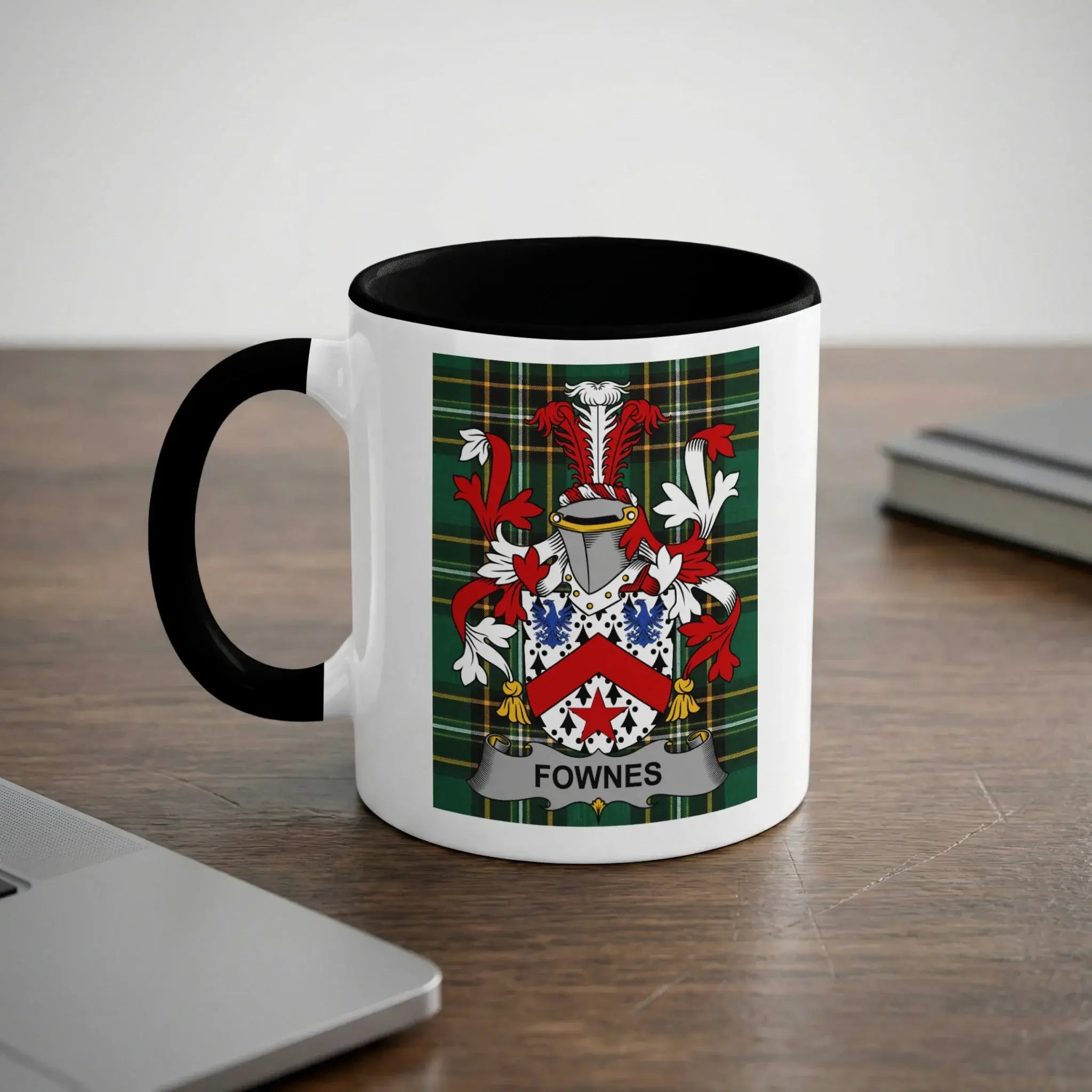 White mug with black rim and handle featuring a Fownes family crest.