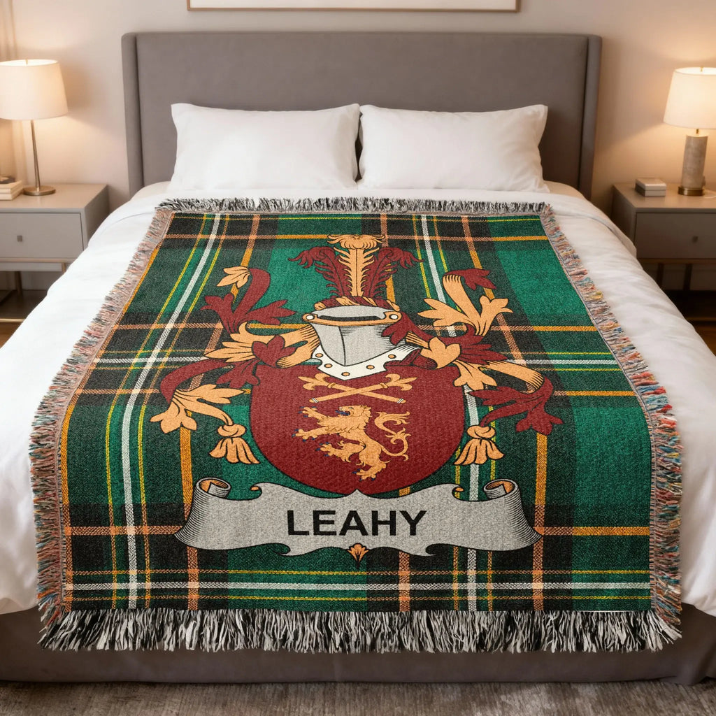 Tartan blanket with LEAHY family crest centered on a bed.