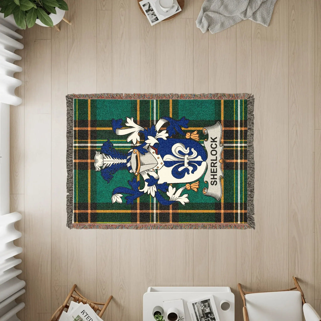 Tapestry with Sherlock family crest on a green and blue tartan plaid.