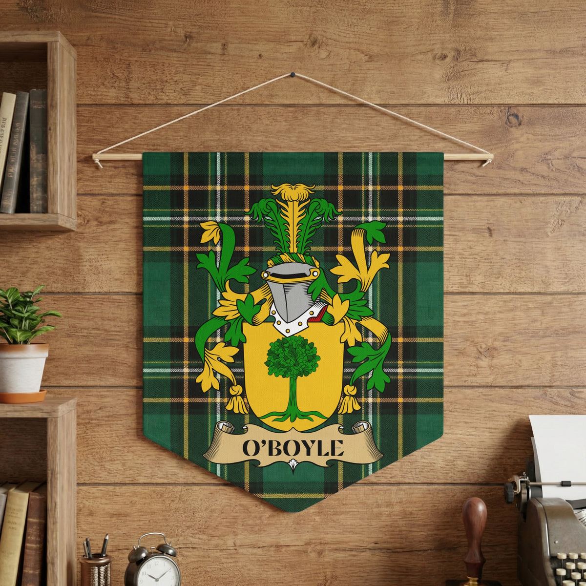 O'Boyle family crest on green tartan banner against wood background.