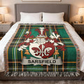 Sarsfield family crest on a tartan blanket draped on a bed.