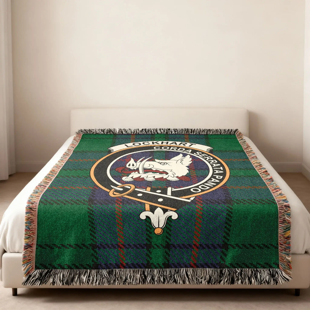 Clan Lockhart tartan woven blanket — lifestyle shot showing fringe border and Corda Serrata Pando motto
