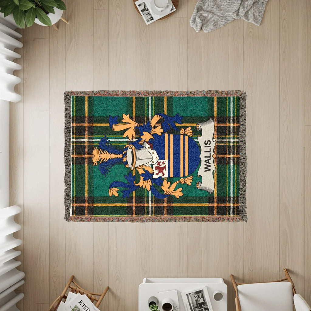 Woven blanket with Wallis family crest on green and blue plaid background.