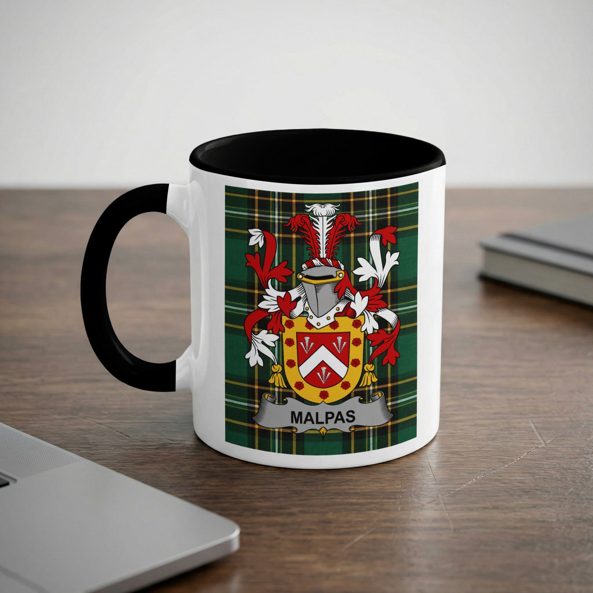 White mug with black handle featuring the Malpas family crest on a tartan background.