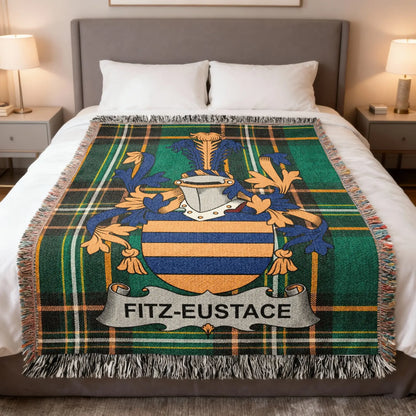 Fitz-Eustace family crest on a green plaid throw blanket.
