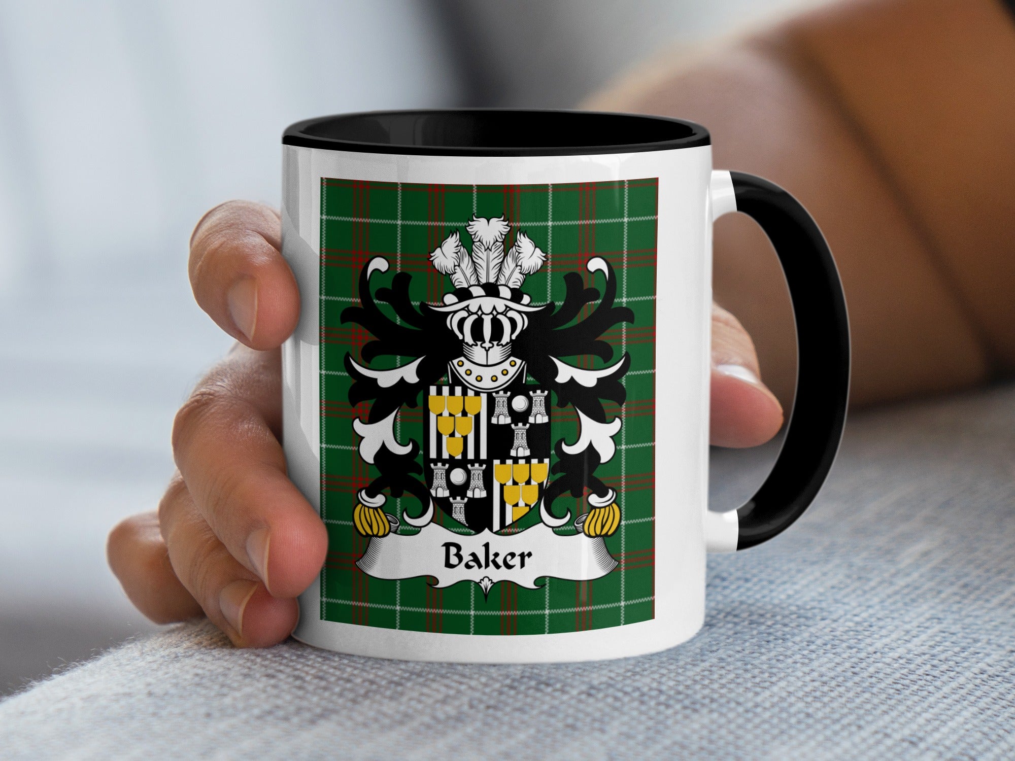 White mug with black handle featuring Baker family crest on green plaid background.