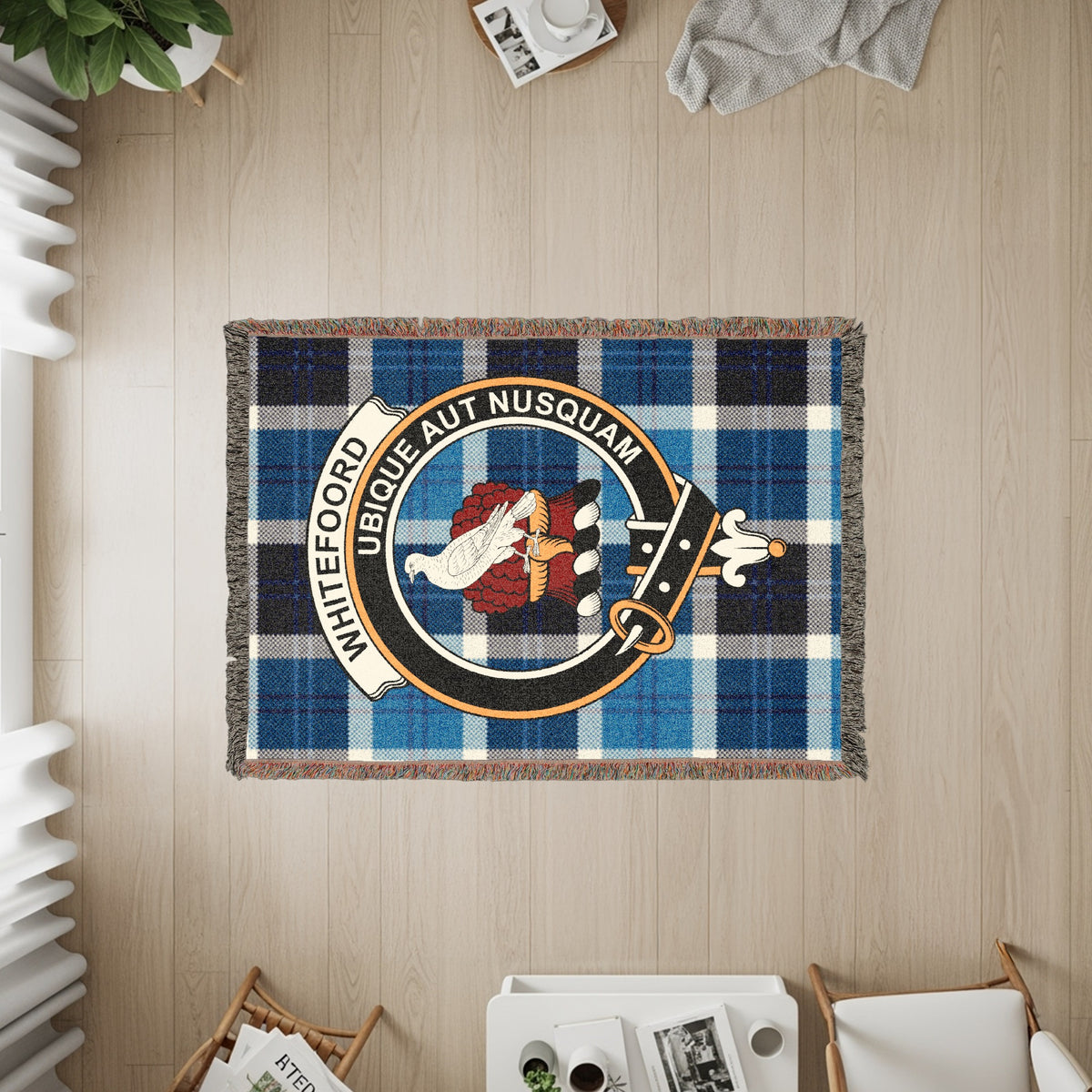 Whitefoord woven blanket displayed on a wall, featuring the crest badge and tartan background