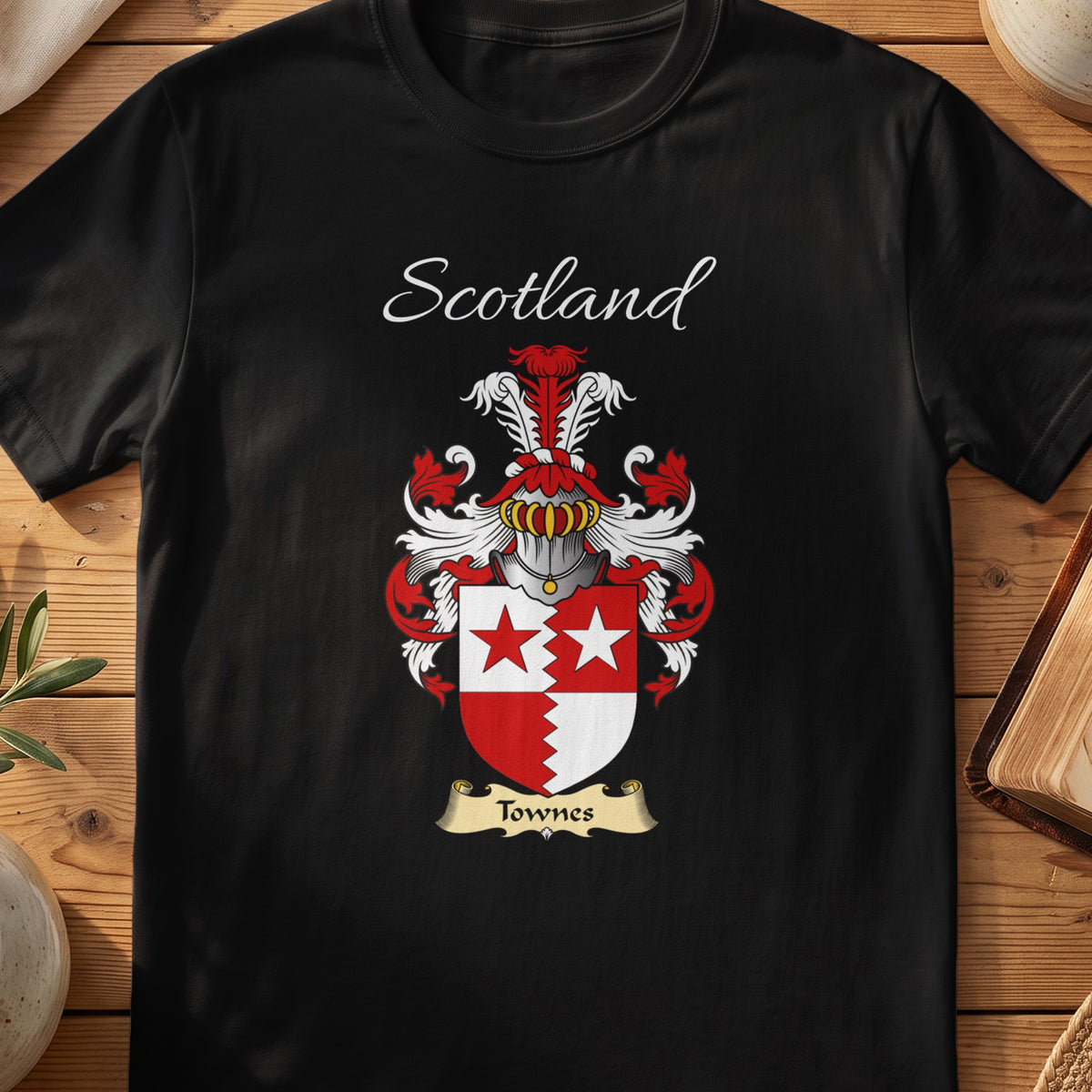 Black Townes Scottish family crest T-shirt laid flat, showing “Scotland” above a red-and-silver shield combining a cross with star details.
