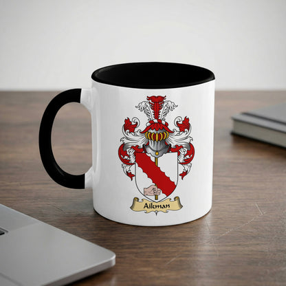 White mug with black handle featuring the Aikman family crest.
