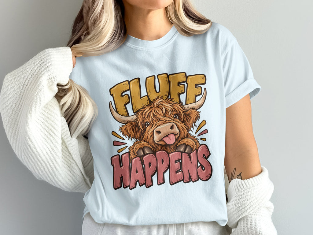 Model wearing the Fluff Happens Highland cow Comfort Colors T-shirt in Chambray
