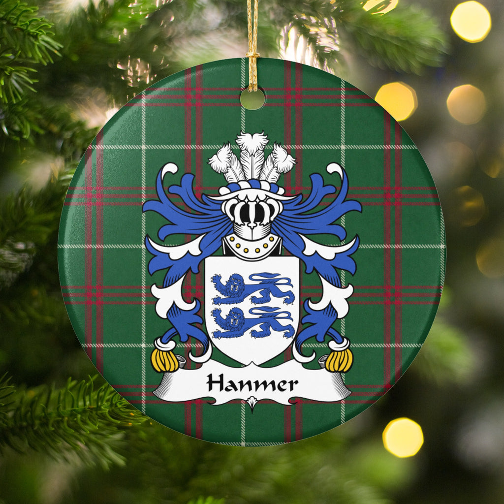 Hanmer ornament hanging in a Christmas tree with warm lights; two blue lions on a white shield on Welsh national tartan.