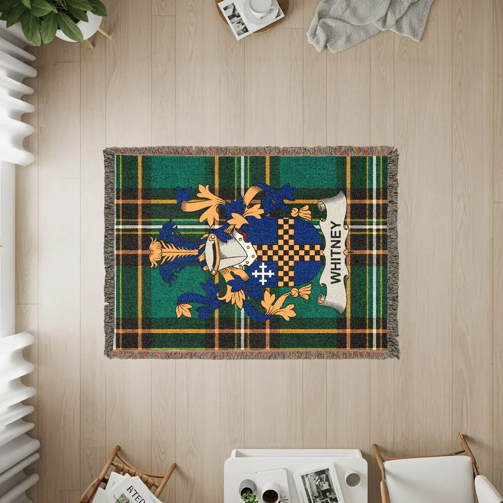 Whitney family crest on a woven plaid blanket.