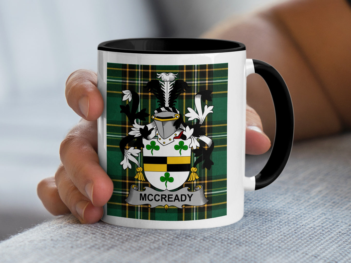 Mug with McCready family crest on a green tartan background.