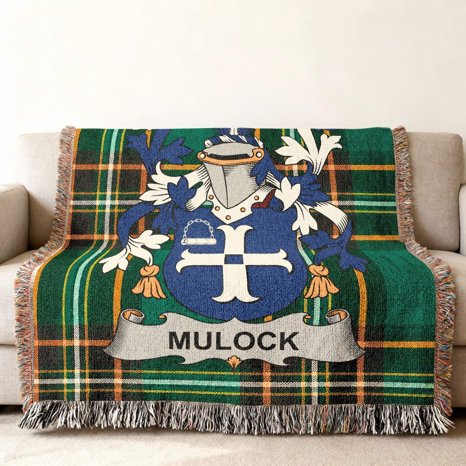 Green plaid blanket with Mulock family crest draped over a sofa.