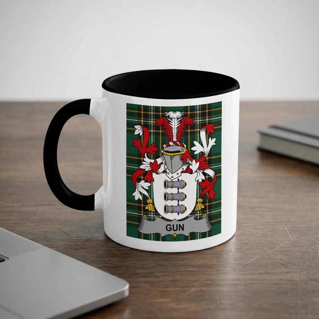 White mug with black rim featuring a family crest with the word "GUN".