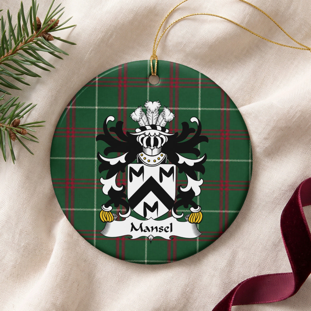 Mansel ornament on cream fabric with gold string, evergreen and burgundy ribbon; a black chevron and three black M-shaped motifs on a white shield on Welsh National Tartan.