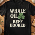 Black T-shirt with “Whale Oil Beef Hooked” text and distressed shamrock graphic.