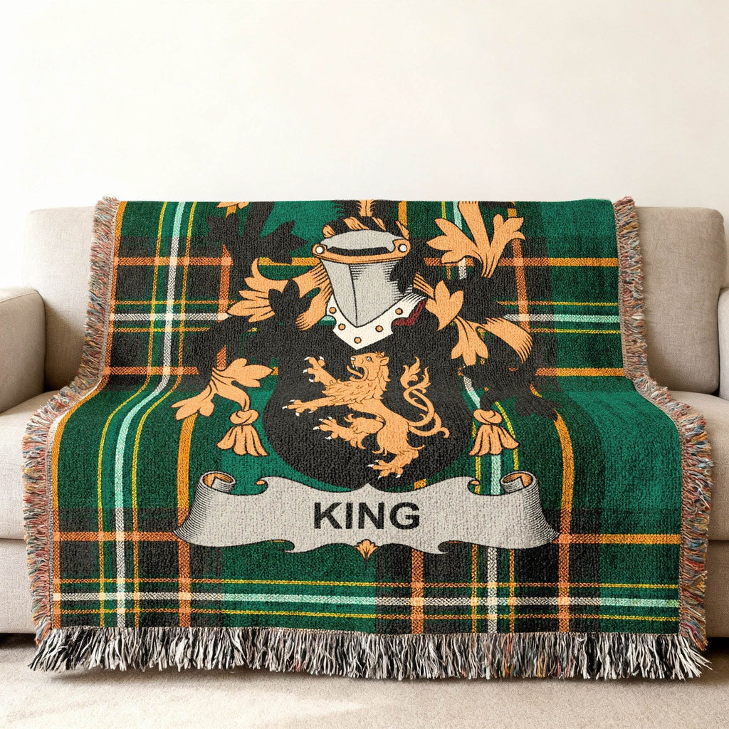 Green tartan blanket with a gold lion crest and the name KING.