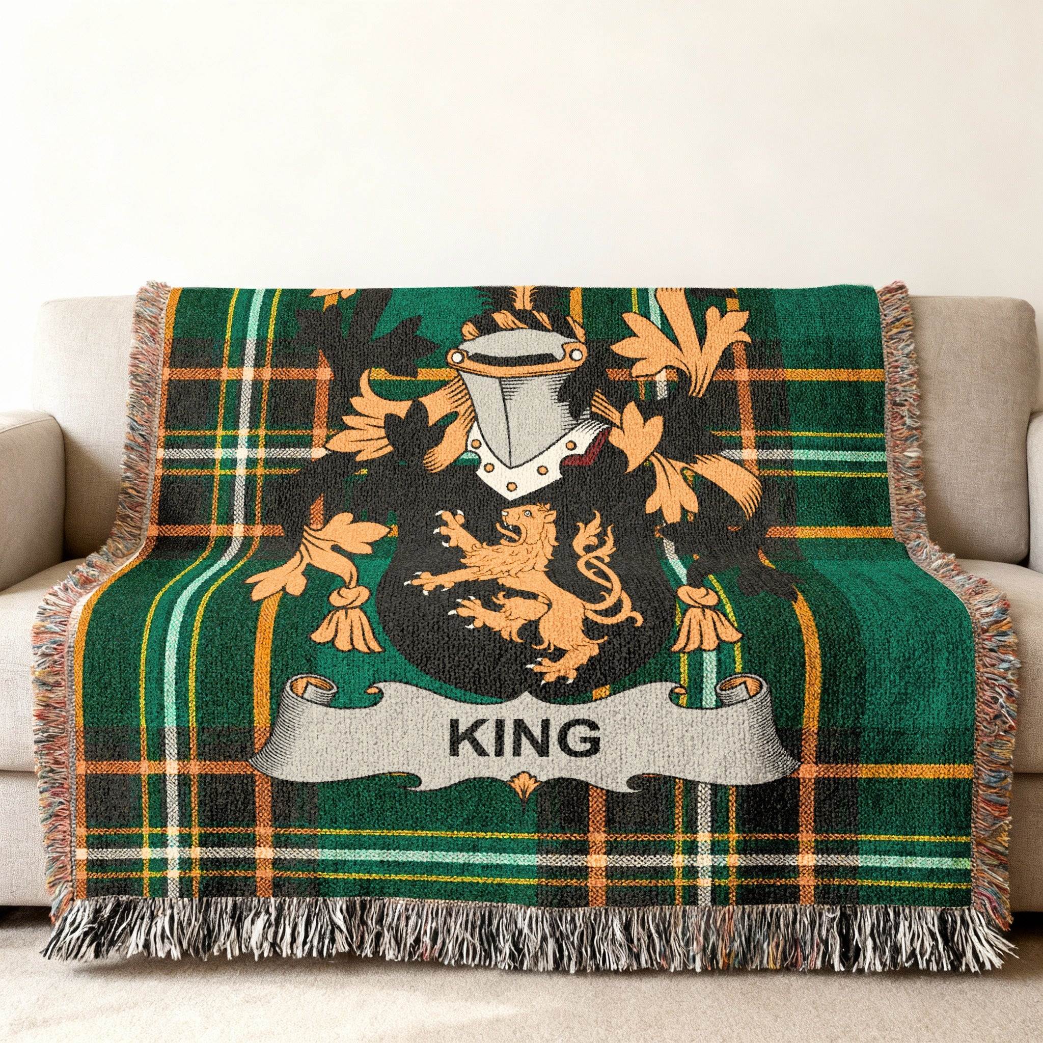 Green tartan blanket with a gold lion crest and the name KING.