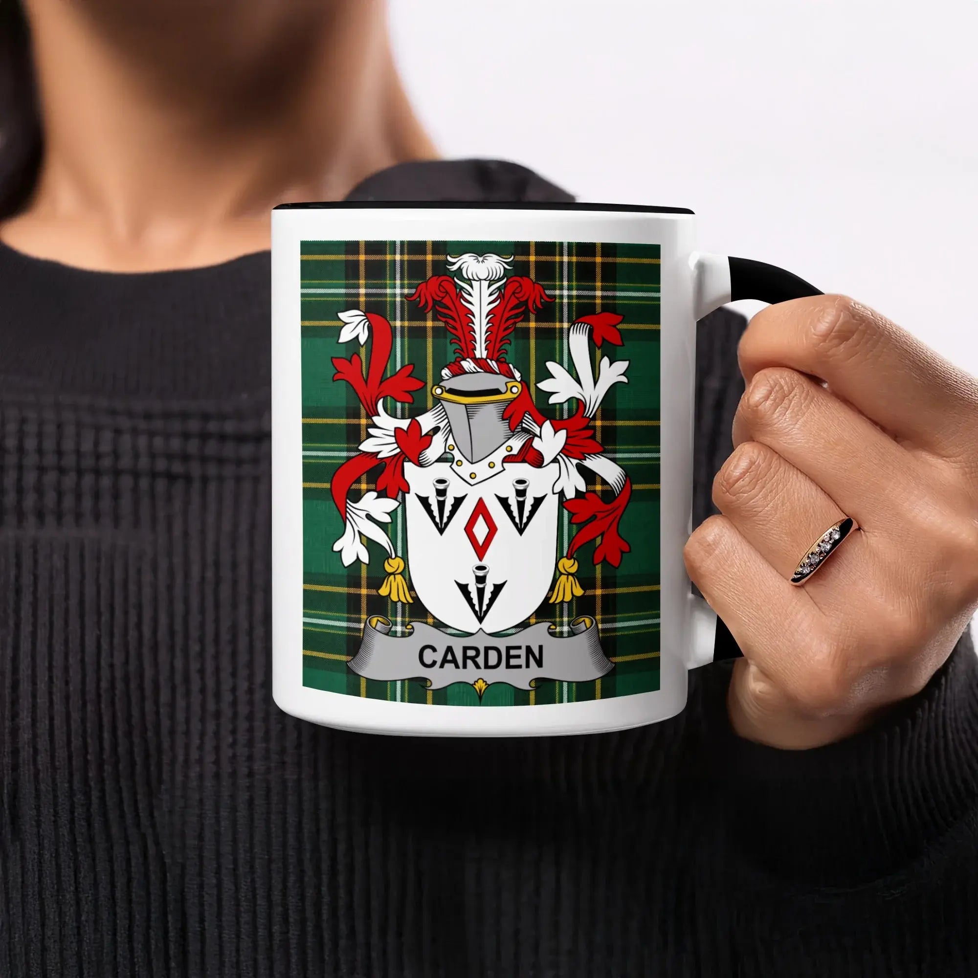 White mug with black handle featuring a green plaid background and the Carden family crest.