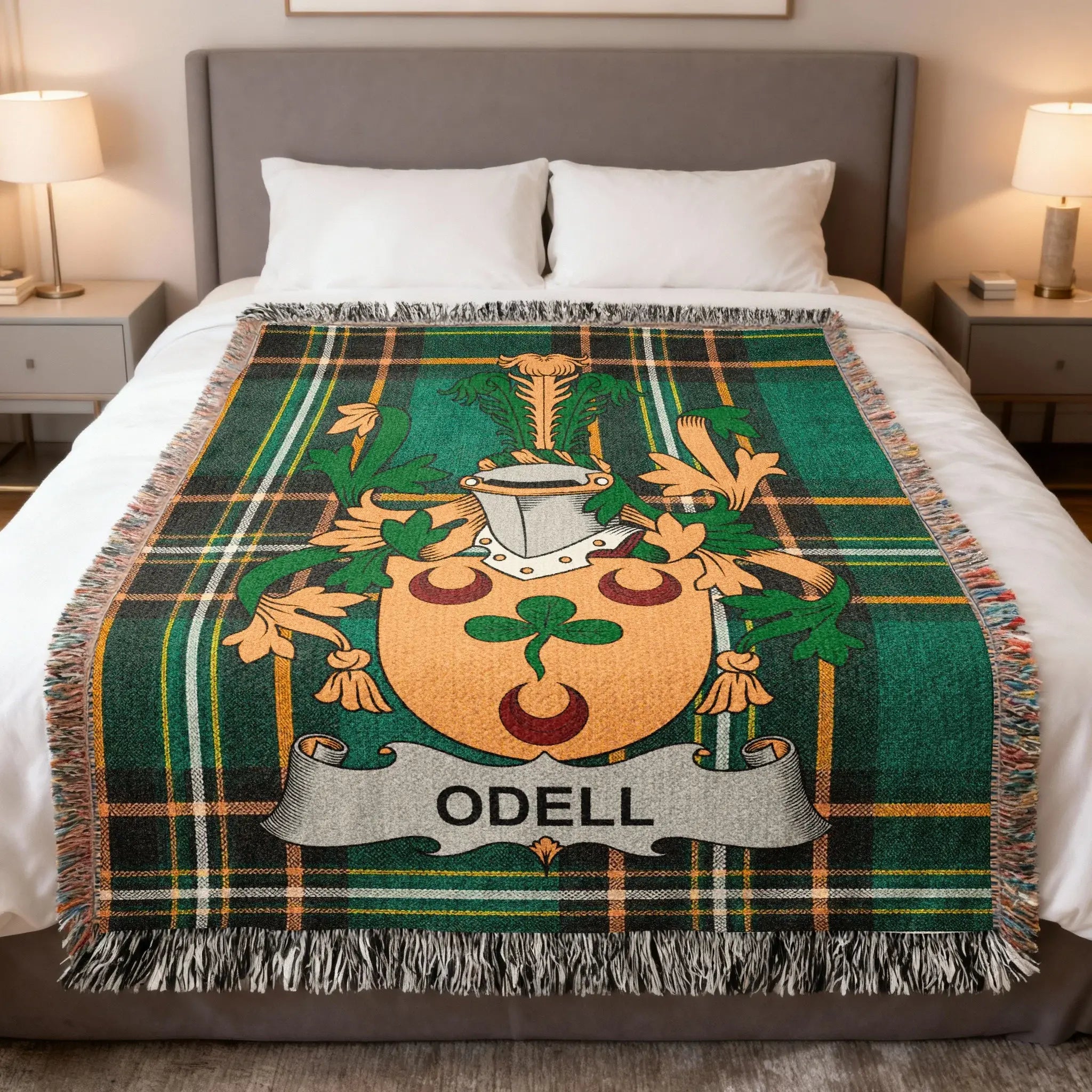 Tartan blanket with Odell family crest draped on a bed.