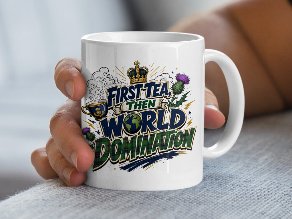 White mug with "First Tea, Then World Domination" and Scottish thistle design.