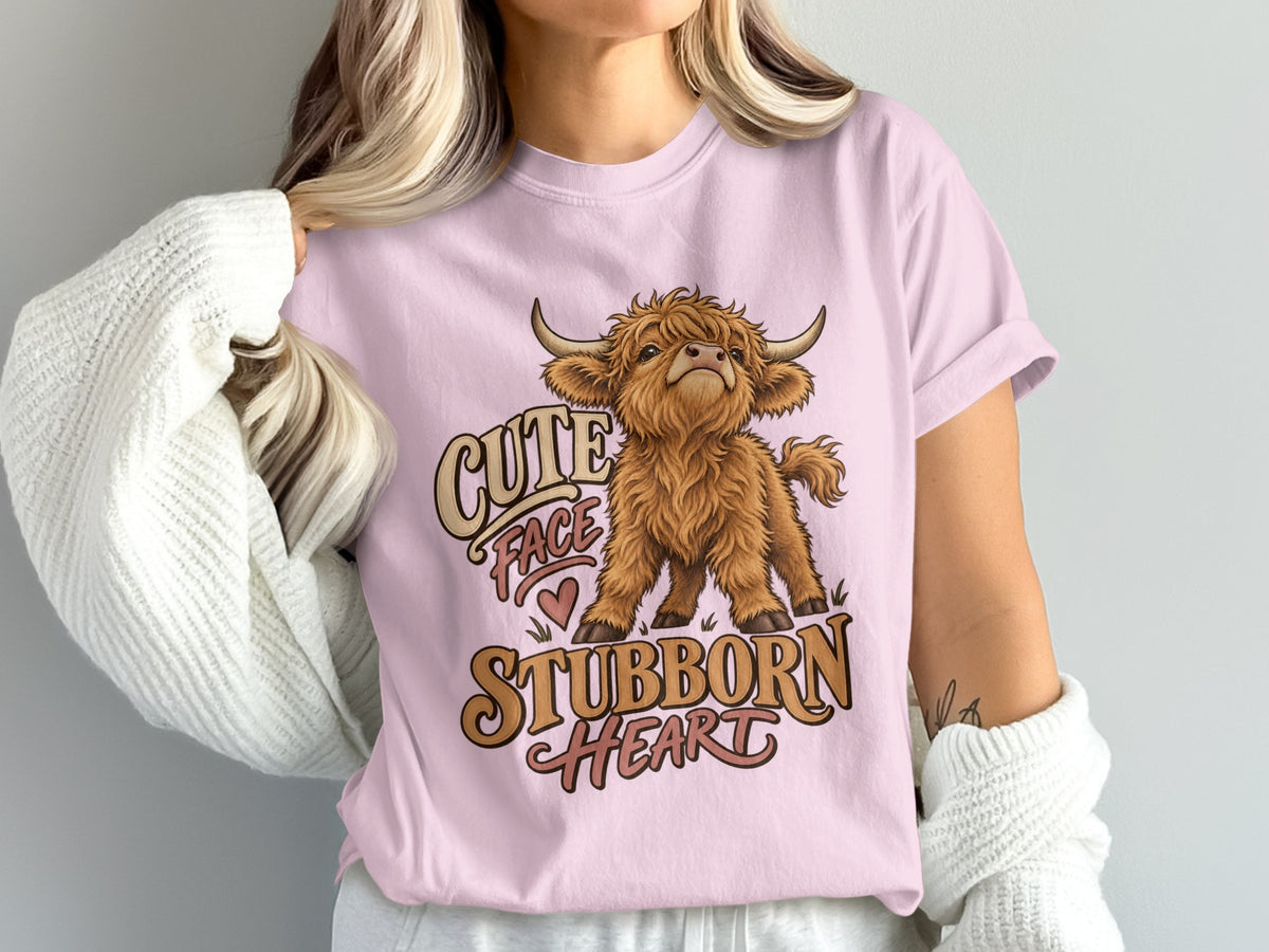 Model wearing the Cute Face, Stubborn Heart Highland cow Comfort Colors T-shirt in Blossom