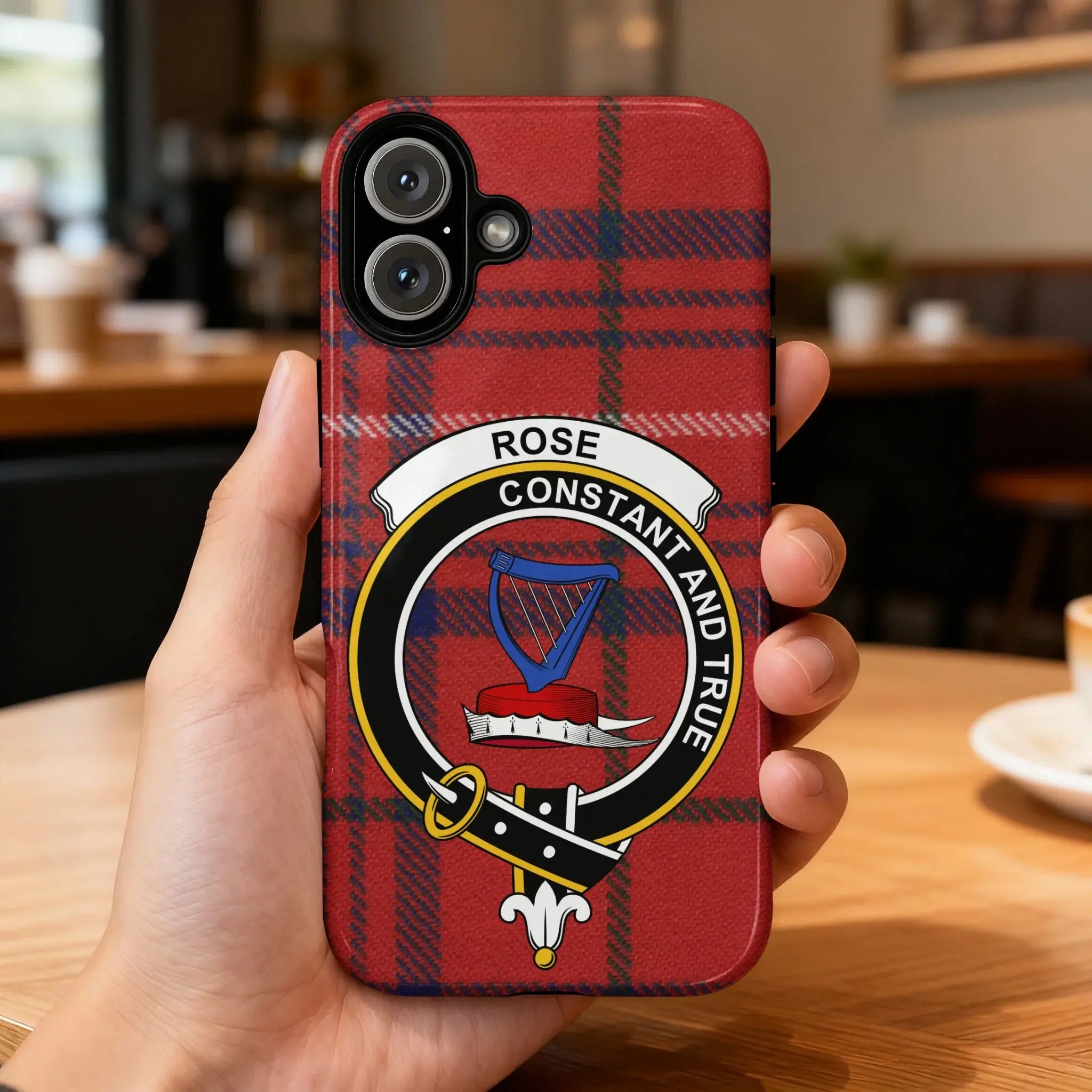 Clan Rose tartan phone case — glossy edge-to-edge red plaid and harp crest print, iPhone shown